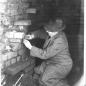 Image 1 taken from inside brick stack, worker looks to be setting dynamite